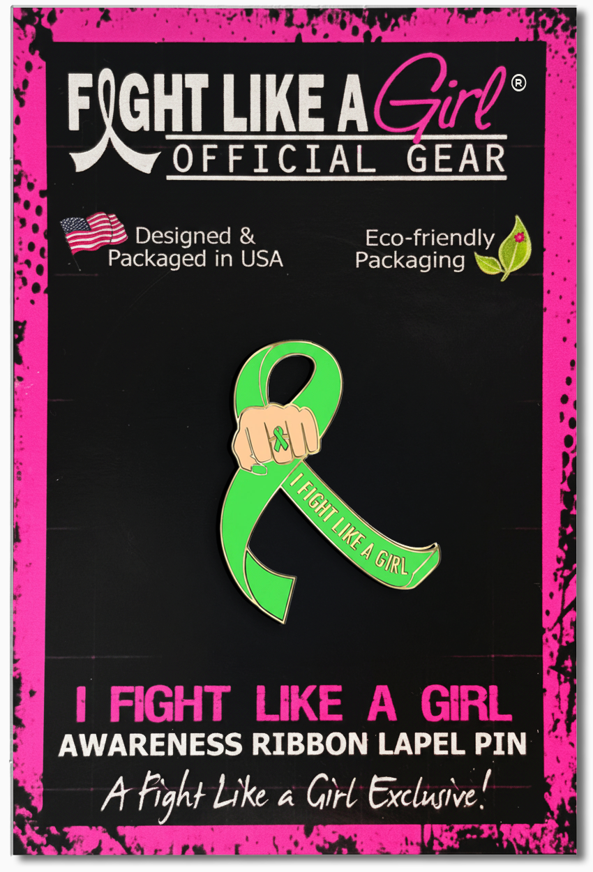 Official Fight Like a Girl awareness ribbon lapel pin in its retail packaging to support non-Hodgkin's lymphoma, general lymphoma, Lyme disease, muscular dystrophy, or any other cause represented by lime green. The lapel pin features a lime green awareness ribbon, a fist wearing a lime green ribbon ring, and the text 'I FIGHT LIKE A GIRL' down one side of the ribbon.