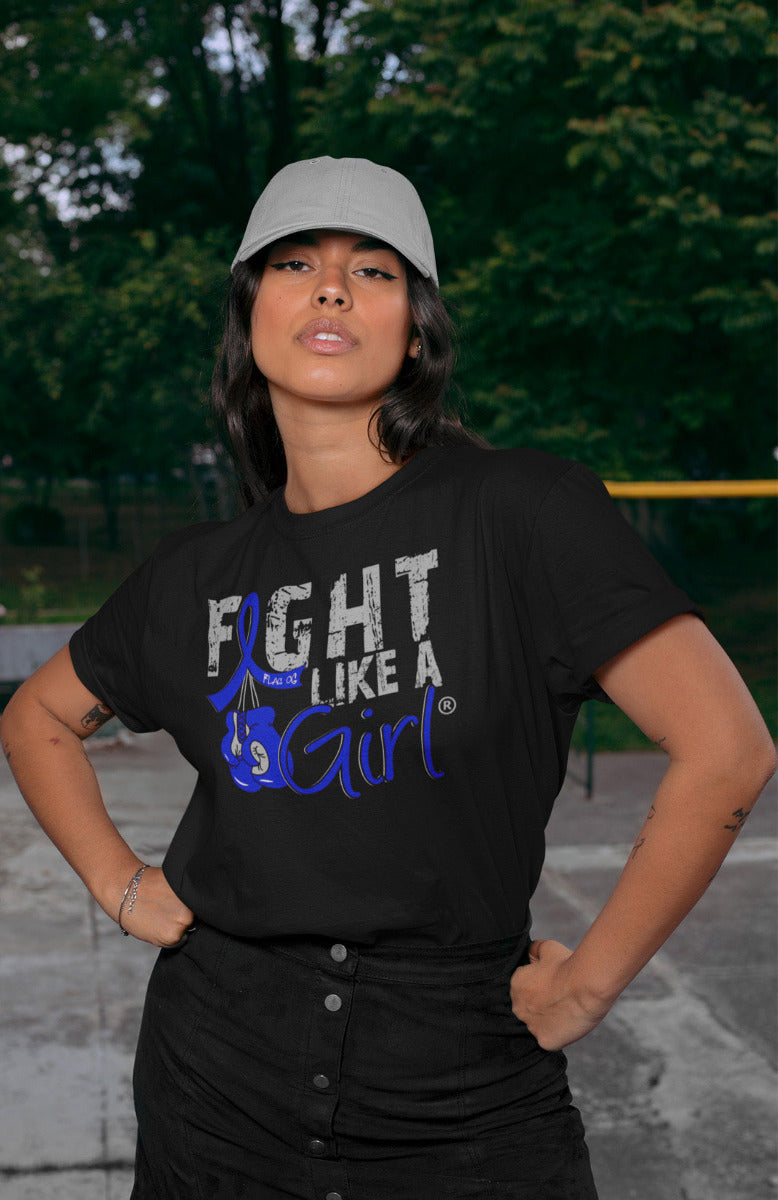 Woman wearing a black unisex t-shirt with the Fight Like a Girl Knockout design in blue on the front. The design says "Fight Like a Girl" and includes boxing gloves hanging from a blue awareness ribbon.