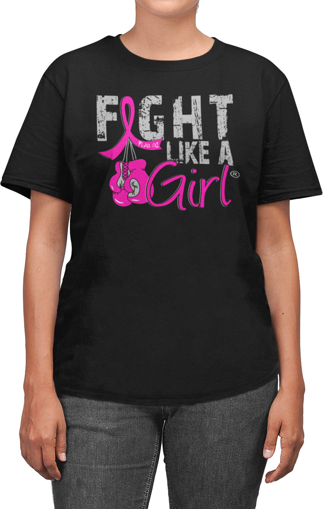 Woman wearing a black unisex t-shirt with the Fight Like a Girl Knockout design in pink on the front. The design says "Fight Like a Girl" and includes boxing gloves hanging from a pink awareness ribbon.