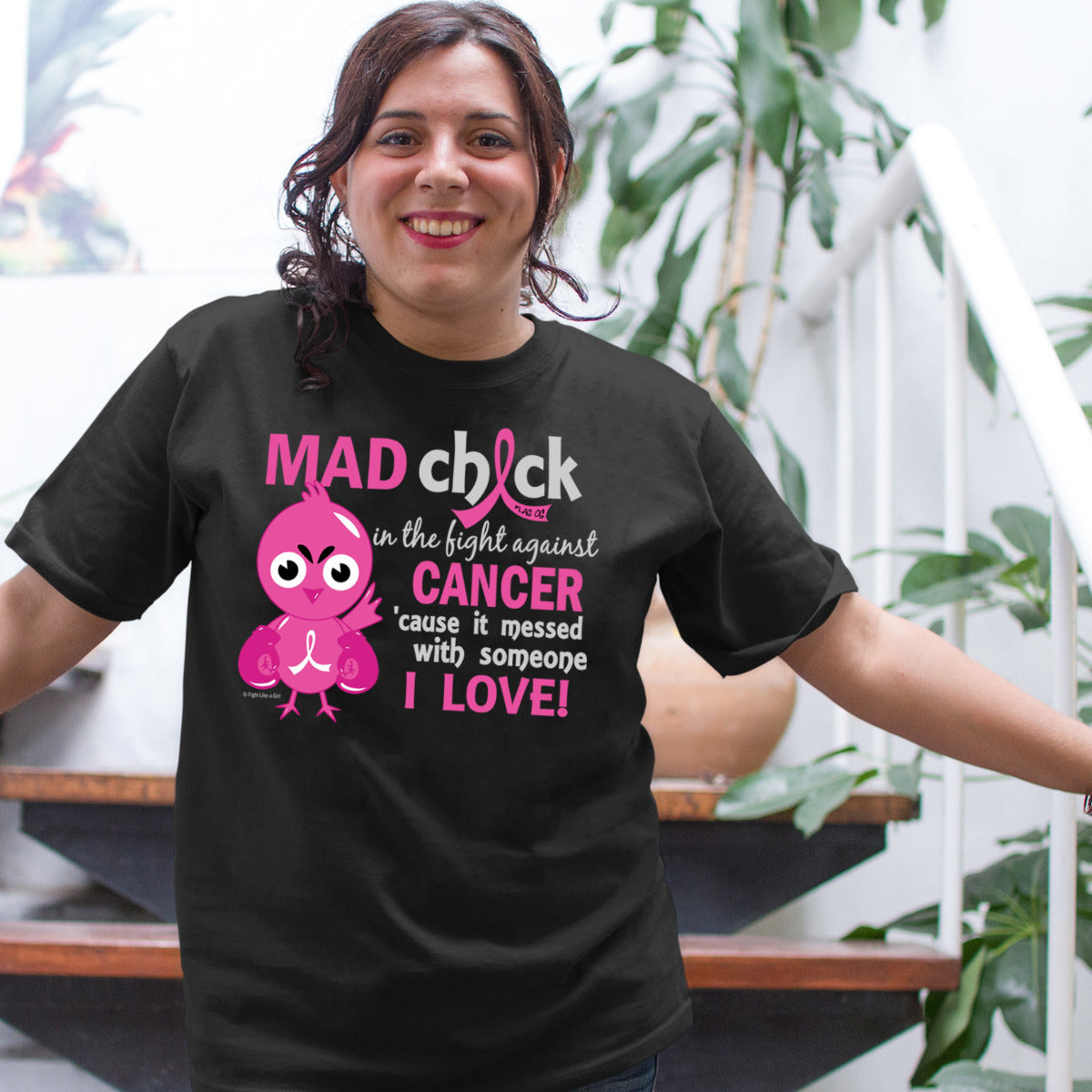 Woman wearing a black unisex t-shirt with the Mad Chick design in pink on the front.
