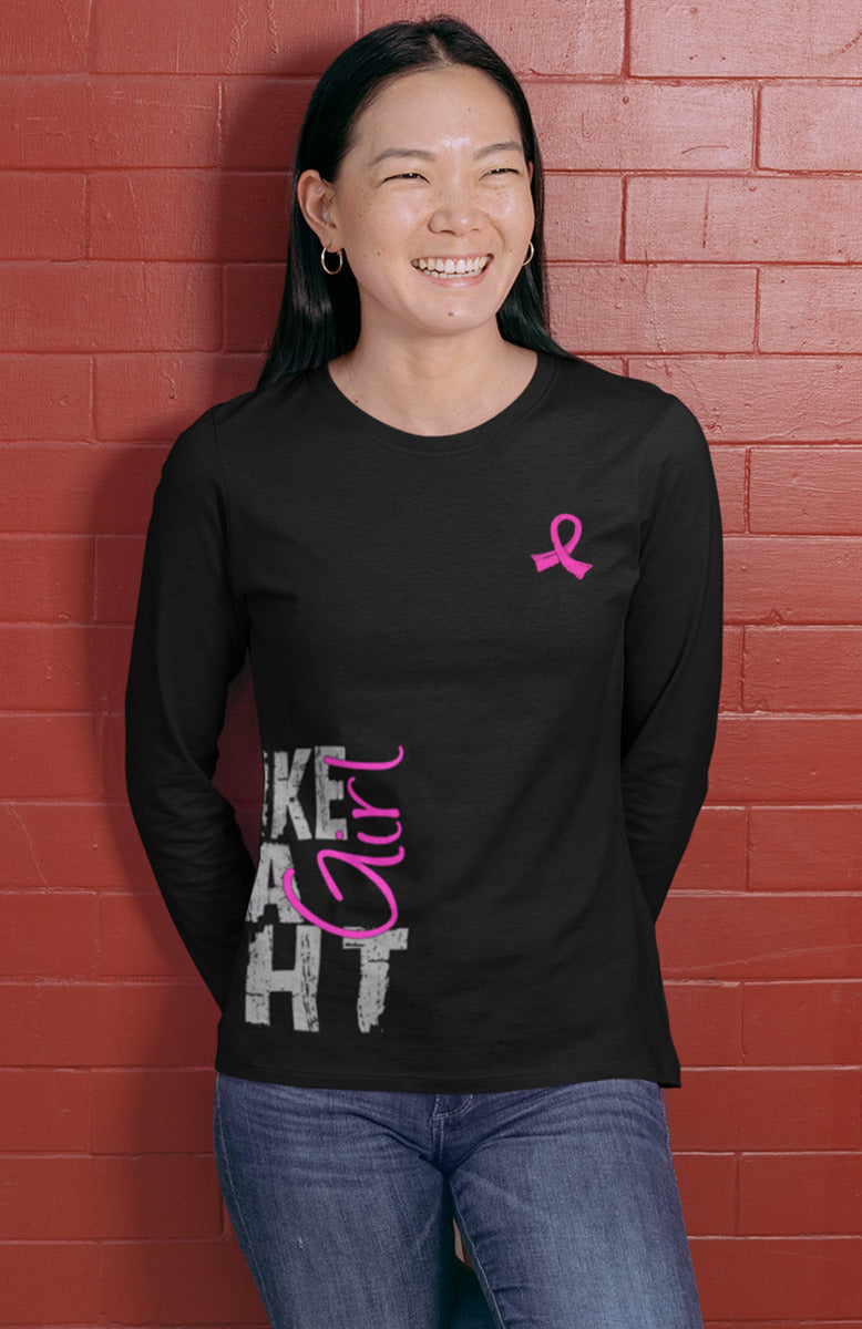 Woman wearing a black women's fit long sleeve t-shirt with the Fight Like a Girl Side Wrap design in pink printed on it.