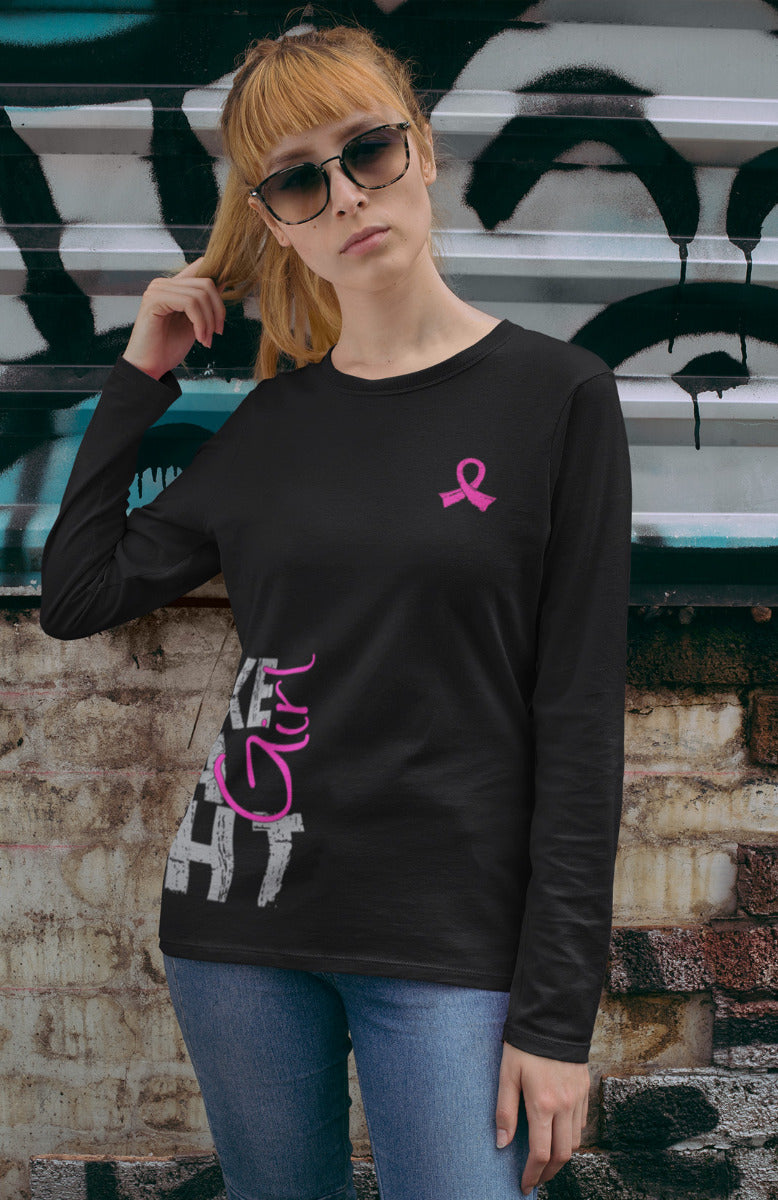 Woman wearing a black women's fit long sleeve t-shirt with the Fight Like a Girl Side Wrap design in pink printed on it.