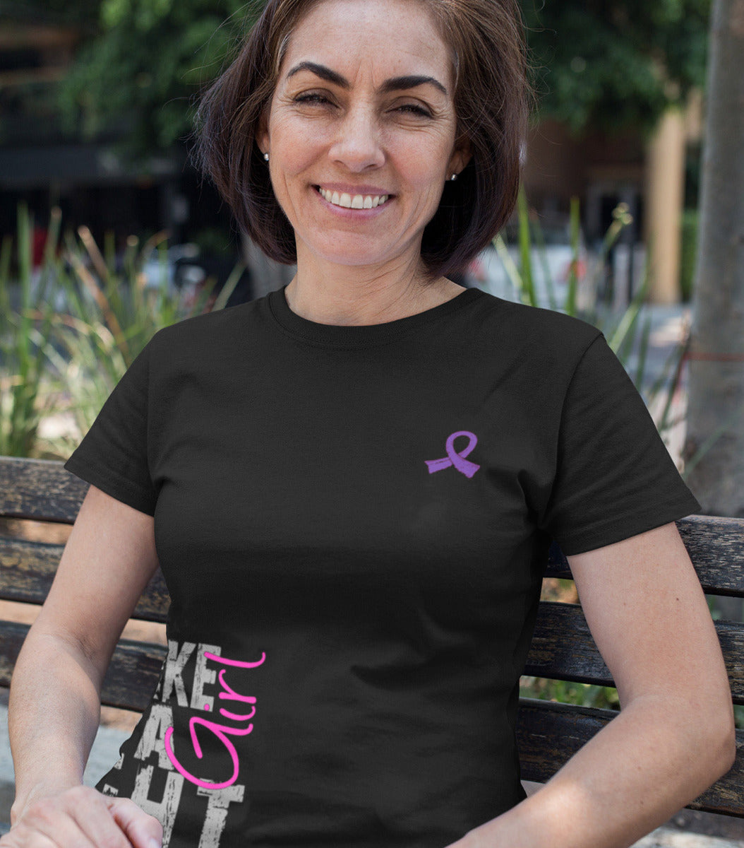 Woman wearing a black women's fit t-shirt with the Fight Like a Girl Side Wrap design in purple and pink printed on it.