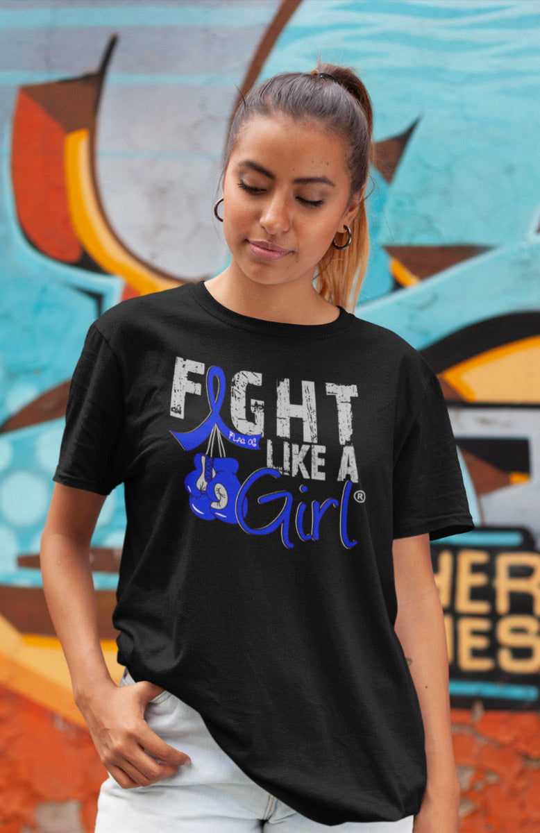 Woman wearing a black unisex t-shirt with the Fight Like a Girl Knockout design in blue on the front.  The design says "Fight Like a Girl" and includes boxing gloves hanging from a blue awareness ribbon.