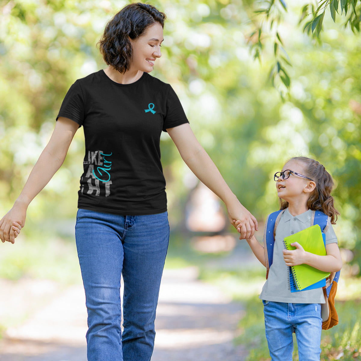 Woman wearing a black women's fit t-shirt with the Fight Like a Girl Side Wrap design in teal printed on it.