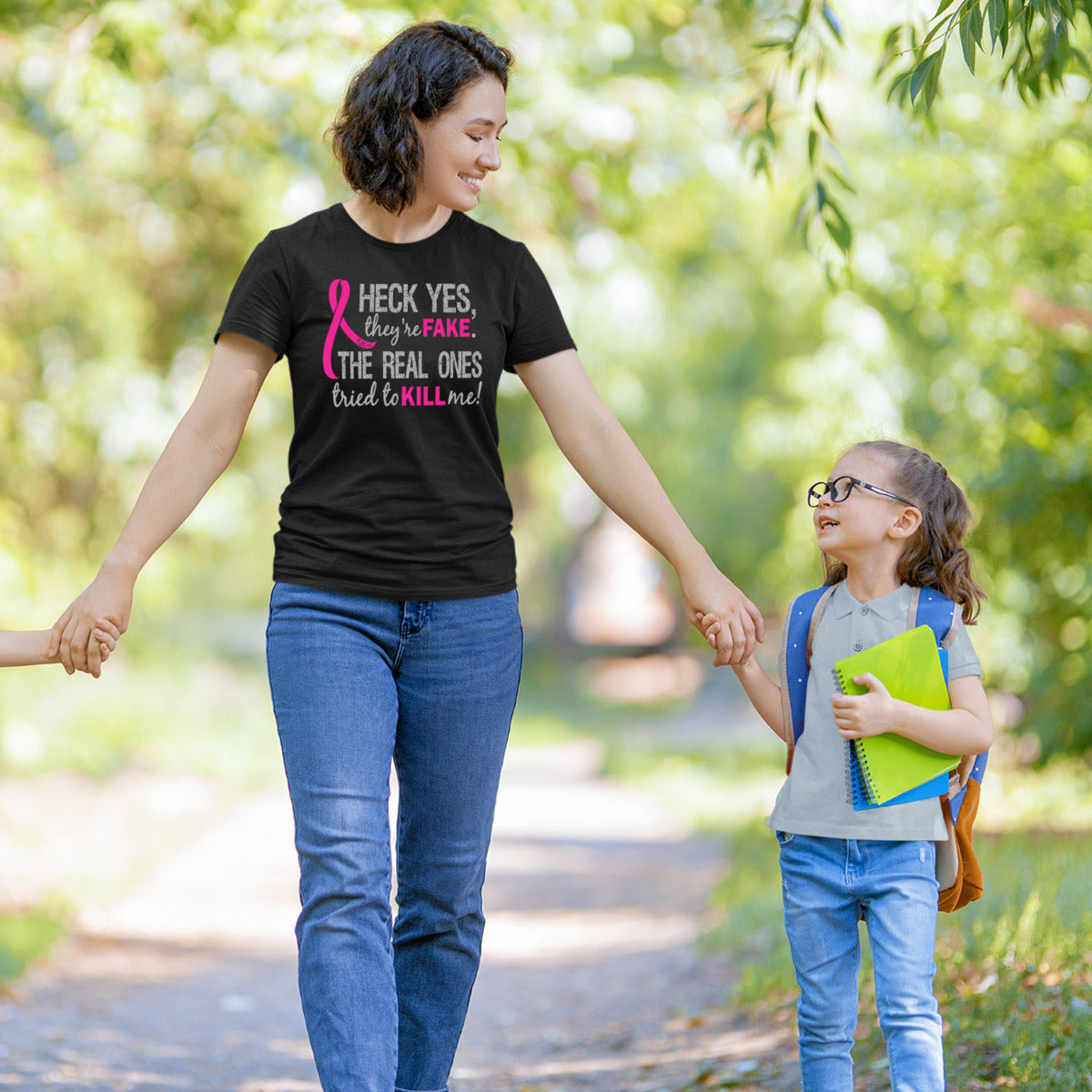 Woman wearing a black women's fit t-shirt with the Heck Yes They're Fake design printed on it.