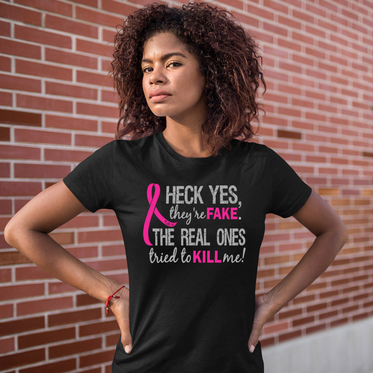 Woman wearing a black women's fit t-shirt with the Heck Yes They're Fake design printed on it.